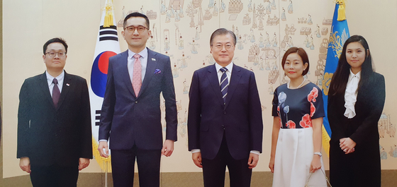 Eric Teo and his wife, Kim Min-jae, pose for a photo with South Korean President Moon Jae-in at the Blue House on Aug. 21.  [Singapore Embassy]