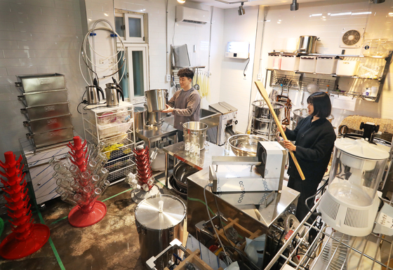 The brewers of Guruma Brewery working in their kitchen in Mapo District. 