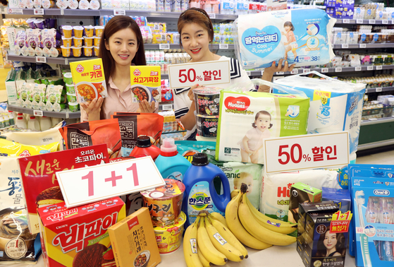 Models pose in front of products that will be on discount at Emart [EMART]