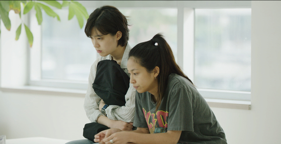 Mi-rae (played by actor Choi Sung-eun) and her best friend (played by Yoo Eden) waiting gloomily for results to come out at the obstetrician-gynecologist. [JIFF] 