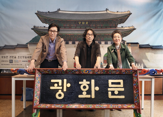 Kang Byung-in, center, and other members of a civic group on hangul, the Korean alphabet of Korea, call for a change to the Gwanghwamun Gate's sign from traditional Chinese to Korean, such as in the example model seen above, during a press conference in central Seoul on May 19. [PARK SANG-MOON]