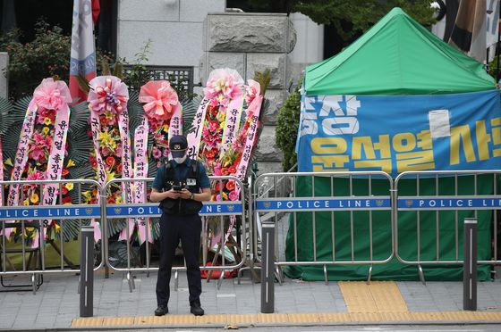In front of the Supreme Prosecutors' Office building in Seocho-dong, Gangnam District of Seoul, flowers sent by the people to express their supports for Prosecutor General Yoon Seok-youl stand next to a protesters' tent demanding Yoon's resignation on June 29, 2020.  [YONHAP] 