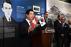 Park, left, speaks at special exhibition "Korea’s Independence Movement and Canadians" at the City Hall in February 2019. Michael Danagher, ambassador of Canada to Korea, is standing second from left. [EMBASSY OF CANADA IN KOREA]