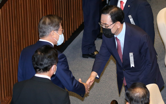 Rep. Joo Ho-young, floor leader of the main opposition United Future Party, right, shakes hand with President Moon Jae-in as Moon leaves the National Assembly after giving a speech on Thursday.  [YONHAP] 