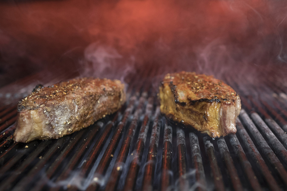 Steaks on a grill. [AP/YONHAP]