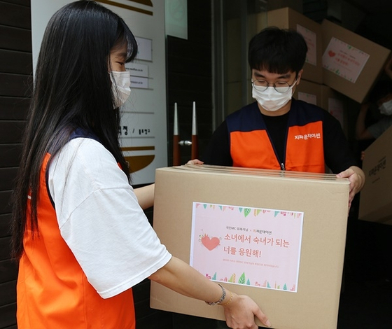 G Foundation workers deliver sanitary kits to a local childrens center. [G FOUNDATION]