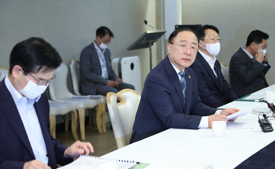 Finance Minister Hong Nam-ki, second from left, presides over a meeting on real estate at the government complex in central Seoul on Wednesday. [YONHAP]