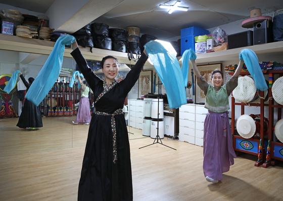 From left, Song Mhin-suk, a licensed dancer of Korean intangible cultural property No. 1 Jongmyo Jeryeak, and Jeon Hee-ja, also a licensed dancer of Korean intangible cultural property No. 97 Salpuri, dance at Jeon's studio in eastern Seoul on July 12. Both are freelance dancers. [PARK SANG-MOON]