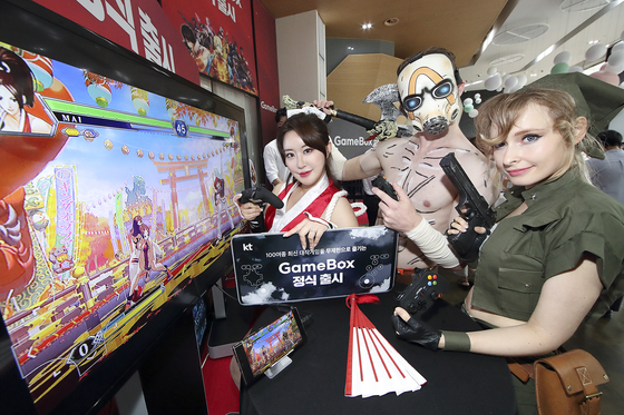 Models play games on KT's cloud gaming platform GameBox at the mobile carrier's headquarters in central Seoul on Wednesday. [KT]