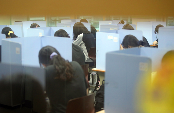 Seniors at Gyeongsan Girls’ High School in Gyeongsan, North Gyeongsang, take a mock College Scholastic Ability Test on Wednesday in a classroom individually partitioned to prevent the spread of Covid-19. [YONHAP]