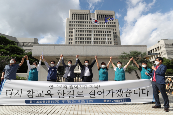 Members of the Korean Teachers and Education Workers Union (KTU) celebrate in front of the Supreme Court in Seocho District, southern Seoul, on Thursday after the top court overturned an appellate court’s ruling and ruled in favor of the progressive teachers’ union. The Supreme Court annulled a decision by the former Park Geun-hye government to outlaw the progressive teachers' union for accepting a handful of fired teachers as its members, opening the way for the union to regain its legal status, and sent the case back to a lower court for retrial. The Supreme Court said denying dismissed teachers the right to join a labor union is unconstitutional and against international standards. It also said depriving the KTU of its legal status just because it had members not employed as teachers was excessive.   [NEWS1]