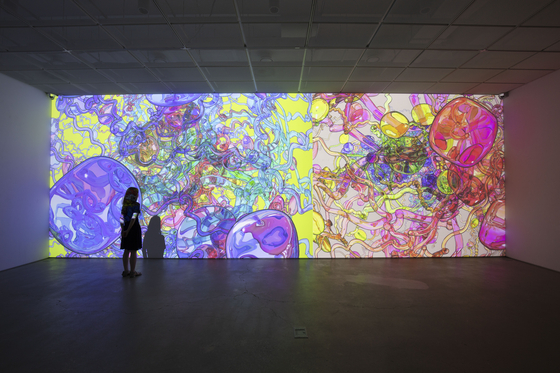 Visitor's shadows become part of Jennifer Steinkamp's video installation ’Retinal 1, 2“ (2019). [Leeahn Gallery]