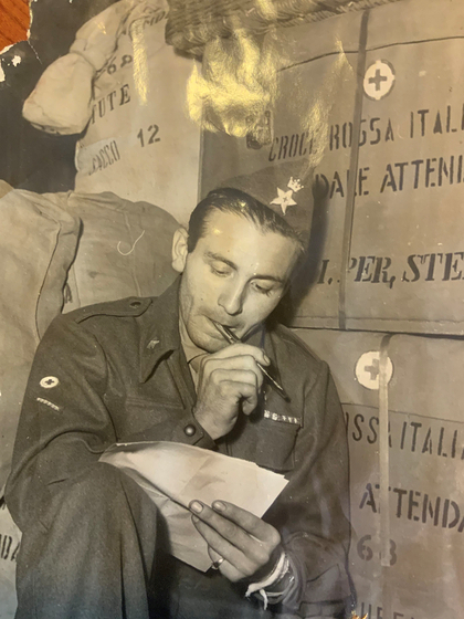 Gianni Riboldi, writing a letter to a friend during his service in Korea at the Italian field hospital during the war. [GIANNI RIBOLDI]