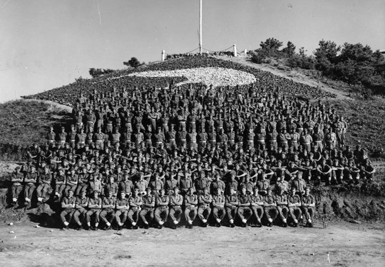 Gunners from the 16th New Zealand Field Regiment pose for a photograph in front of Kiwi Hill at the regiment's headquarters in Korea in 1953. The photo has been provided by Sue Corkill, author of "Korea: A Kiwi Gunner's Story," published by Fern Publishing in 2014. [SUE CORKILL] 