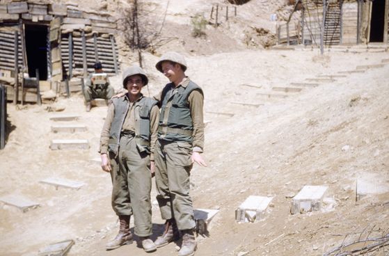 Diaz, right, with his friend Pedro Martinez in the fortified positions of the Colombia Battalion. [GILBERTO DIAZ VELASCO]