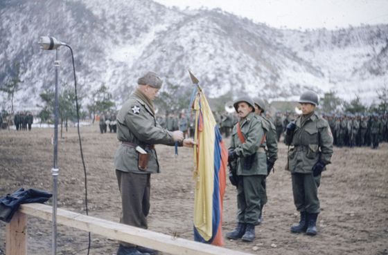 U.S. General James Van Fleet awards the Presidential Unit Citation to the Colombian Flag, in recognition of the heroism and acts of courage displayed by the troops in the Korean War, during a ceremony held Dec. 9, 1952. Lieutenant Edgardo Vallejo carries the standard. [GILBERTO DIAZ VELASCO]
