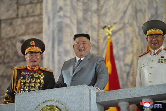 North Korean leader Kim Jong-un, center, and top officials smile during a military parade to commemorate the 75th anniversary of the ruling Workers' Party Saturday. [YONHAP]