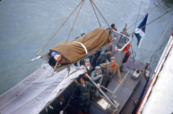 A wounded soldier being transported onto Jutlandia from a helicopter. [DANISH JUTLANDIA VETERANS]