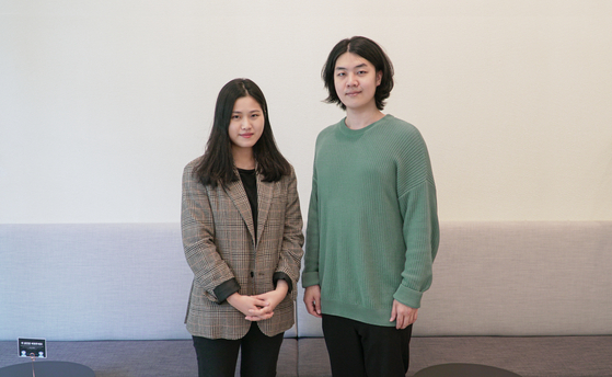 Jeong Jae-ryeong, art director of COSDOTS (left), and Kim Hae-min, creative director, pose for photos in an interview with the Korea JoongAng Daily in their office in Seongsu-dong, eastern Seoul. [JEON TAE-GYU]