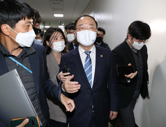 Finance Minister Hong Nam-ki is surrounded by reporters after exiting a meeting with lawmakers at the National Assembly on Nov. 3 in Seoul. [YONHAP]