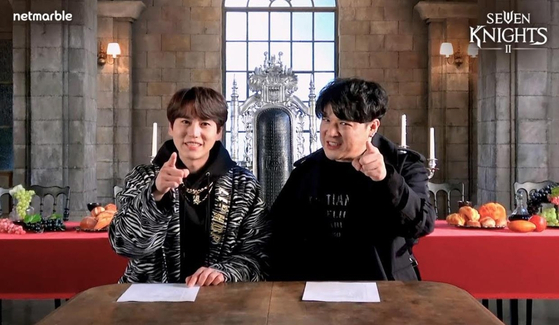 Kyuhyun, left, and Shindong feature in a two-part web variety show which covers the process of how they created the theme song and music video for Netmarble's upcoming massively multiplayer online role-playing game (MMORPG) Seven Nights 2. [NETMARBLE] 