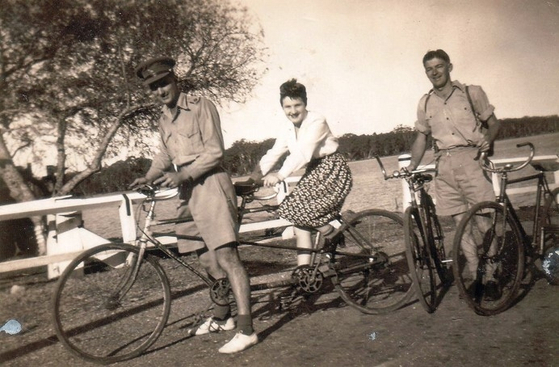 Lt. Col. Charles Green, left, and his wife Olwyn Green on a tandem bike with Ron Diamond. The photo has been provided by the Green family to the Australian War Memorial. [AUSTRALIAN WAR MEMORIAL]