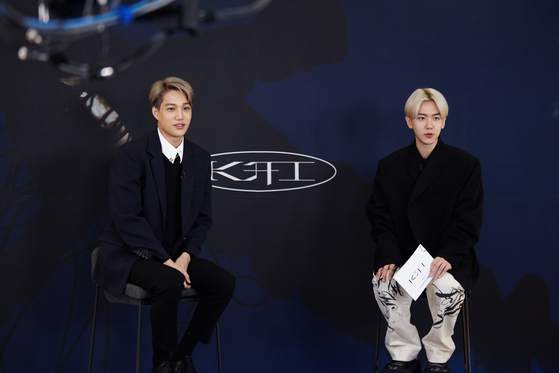 Singer Kai sits down with member Baekhyun of Exo on Monday morning for his first solo album ″KAI.″ [SM ENTERTAINMENT]