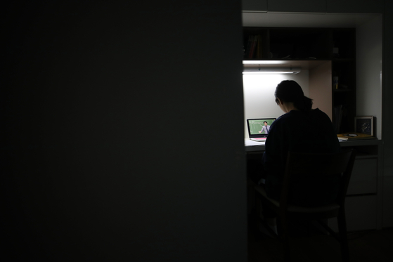 A student takes an online class at home in Seoul in April. [YONHAP]