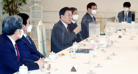President Moon Jae-in speaks on vaccine procurement worries in a meeting with the five highest national leaders under the Constitution in the Blue House in central Seoul Tuesday. [JOINT PRESS CORPS]