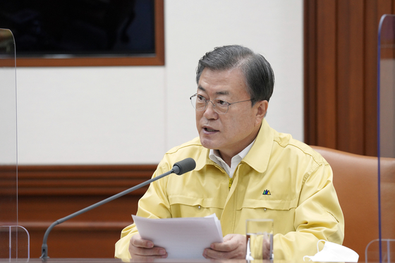 At a meeting on Dec. 13 of the Central Disaster and Safety Countermeasures Headquarters in Seoul, President Moon Jae-in urges drastic action on social distancing if needed. [JOINT PRESS CORPS]