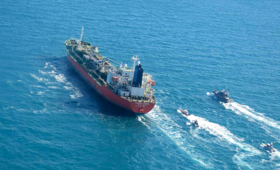 MT Hankuk Chemi, a South Korean-flagged oil tanker, is escorted by Islamic Revolutionary Guard vessels Monday to Iranian waters after being seized by Iranian authorities in the Strait of Hormuz in a photo released by the Tasnim News Agency. [AFP/YONHAP]
