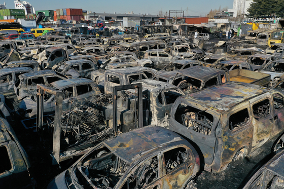 Scores of vehicles are burnt in a yard of a company that exports used cars in Incheon on Tuesday. [YONHAP]