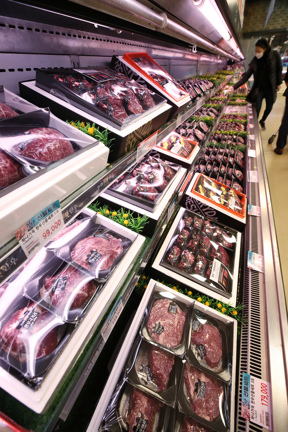 A visitor at a supermarket in Seoul Sunday peruses packages of hanwoo, or Korean beef, that are gift-packaged for the Lunar New Year holiday. Due to the coronavirus, people are opting for expensive gift sets instead of offline gatherings. [YONHAP]