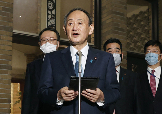 Japan's Prime Minister Yoshihide Suga speaks to the press after having his first phone talk with U.S. President Joe Biden on Thursday.  [YONHAP] 