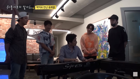 A captured image of Sechs Kies members and Yoo Hee-yeol, center, as they work on an upcoming track. [SCREEN CAPTURE]