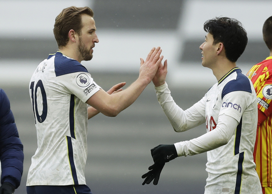 Tottenham Hotspur's Harry Kane and Son Heung-min celebrate after beating West Brom 2-0 at Tottenham Hotspur Stadium in London on Sunday. [REUTERS/YONHAP]