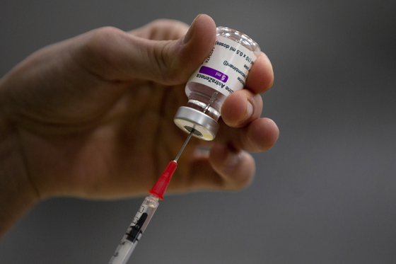 A pharmacist prepares a syringe from a vial of the AstraZeneca coronavirus vaccine during preparations at the Vaccine Village in Antwerp, Belgium, on Feb. 19. [AP]
