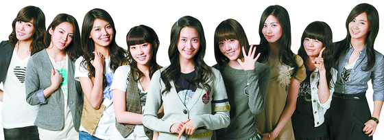 Yoona, standing in the center, was the center of girl group Girls' Generation — setting the tone for girl groups that came after their debut in 2007. [SM ENTERTAINMENT] 
