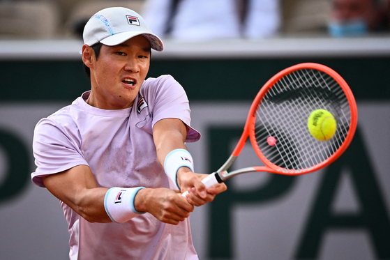 Kwon Soon-woo returns the ball to Italy's Matteo Berrettini during their men's singles third round tennis match on Day 7 of The Roland Garros 2021 French Open tennis tournament in Paris on Saturday. [AFP/YONHAP]