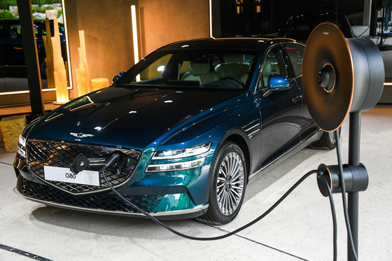 Electric version of the Genesis G80, left, and the brand's home charging equipment on the right [HYUNDAI MOTOR]