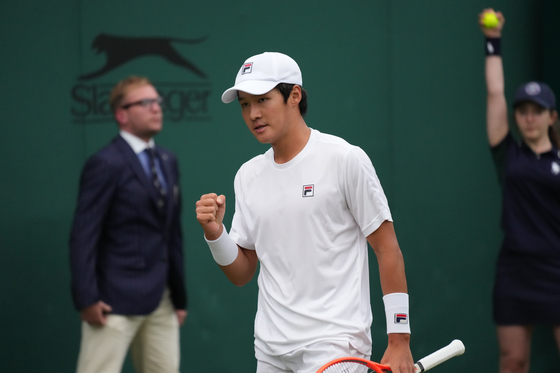 Kwon Soon-woo celebrates winning a point against Germany's Dominik Koepfer during the men's singles second round match on day three of the Wimbledon Tennis Championships in London on Wednesday. [AP/YONHAP]