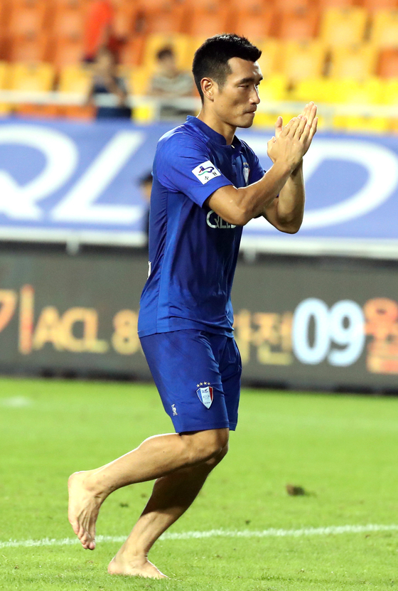 Cho Won-hee runs barefoot at the end of a Suwon Samsung Bluewings game in August, 2018. [ILGAN SPORTS]