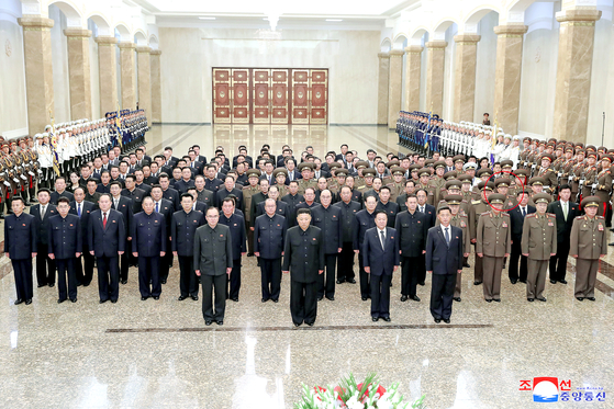 North Korean leader Kim Jong-un, center, pays tribute to his grandfather and regime founder Kim Il Sung alongside high-ranking Workers' Party members and military officials on the 27th anniversary of his death at the Kumsusan Palace of the Sun in Pyongyang on Thursday. [KCNA]