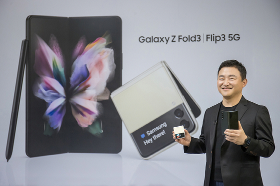 Roh Tae-moon, head of Samsung's Mobile Communications Business, holds a Galaxy Z Fold 3 and Galaxy Z Flip 3 during an Unpacked event, which was held virtually on Wednesday. [SAMSUNG ELECTRONICS]
