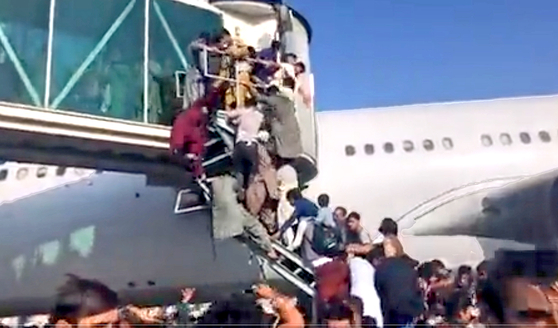 Mayhem at the airport in Kabul on Sunday as people try to evacuate out of the country after the Taliban forces swept into the Afghan capital. [SCREEN CAPTURE FROM A TWITTER ACCOUNT]