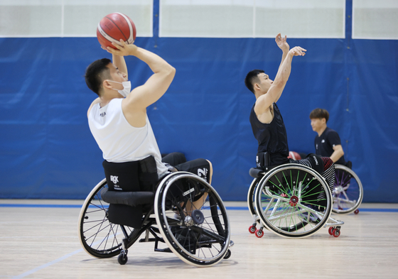 The Korean Paralympic basketball team shoot hoops at the Korea Paralympic Committee Icheon National Training Center in Icheon, Gyeonggi on Tuesday, one week before the 2020 Tokyo Paralympics begins on Aug. 24. [YONHAP]