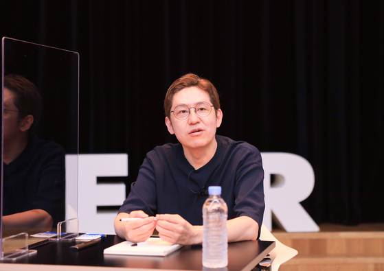 Naver Webtoon's CEO Kim Jun-koo sits down for an online press conference on Wednesday morning, where he revealed that Naver Webtoon will be collaborating with HYBE and DC Comics. [NAVER WEBTOON]