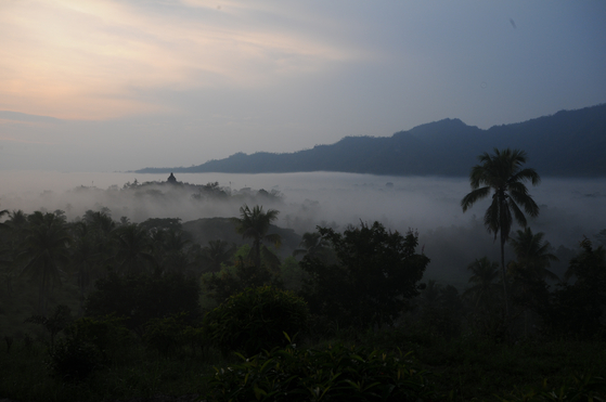 Borobudur Temple Compounds during a sunrise on a misty day [BOROBUDUR PARK MANAGEMENT]