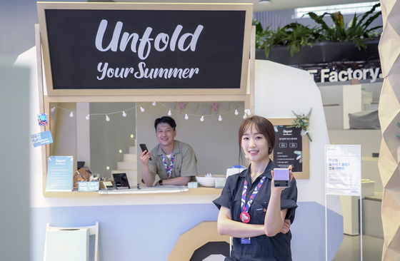 Staffers at SK Telecom's ICT multiplex dubbed T Factory in Hongdae, western Seoul, welcome visitors to the Galaxy Z Fold 3 and Galaxy Z Flip 3 experience zone on Tuesday. The event will be held until Aug. 27. [SK TELECOM]