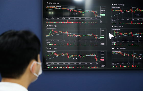 Prices of cryptocurrencies are displayed at a digital screen at Coinone's customer service center in Yongsan District, central Seoul, last week. Bitcoin is traded at around $48,000 as of 2:30 p.m. Monday according to CoinMarketCap. [YONHAP]